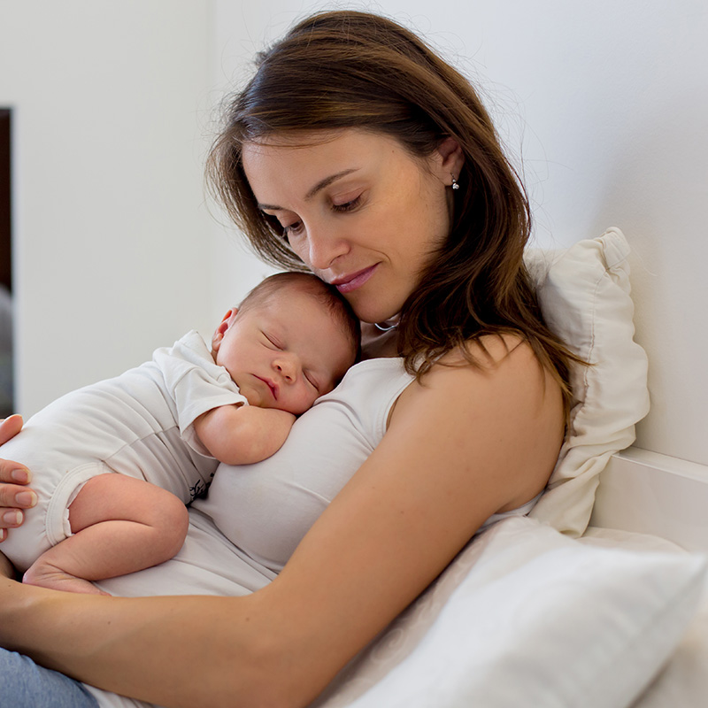 Sad mom holding baby