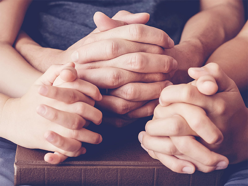 Hands clasped together in prayer