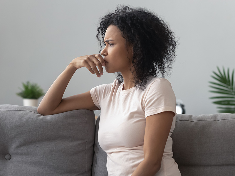 Woman sad on couch