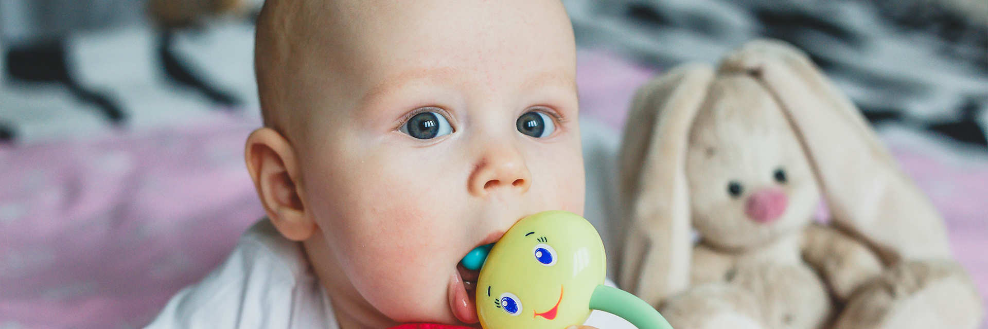 Baby with toy in mouth