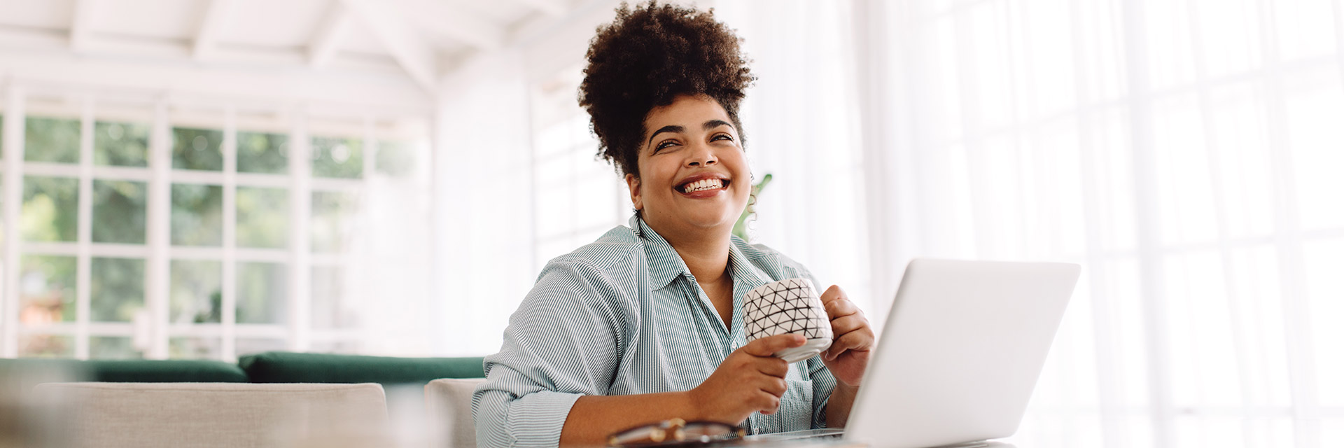 Woman smiling in front of her laptop