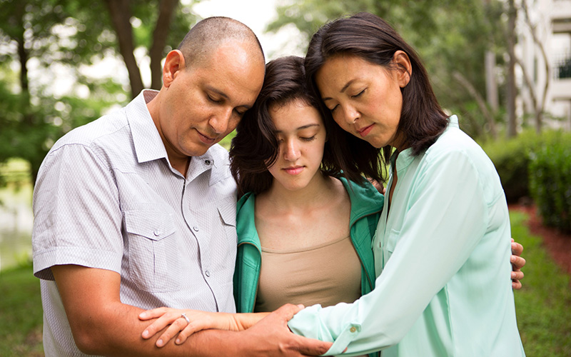 Three people in prayer