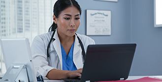 Doctor using laptop