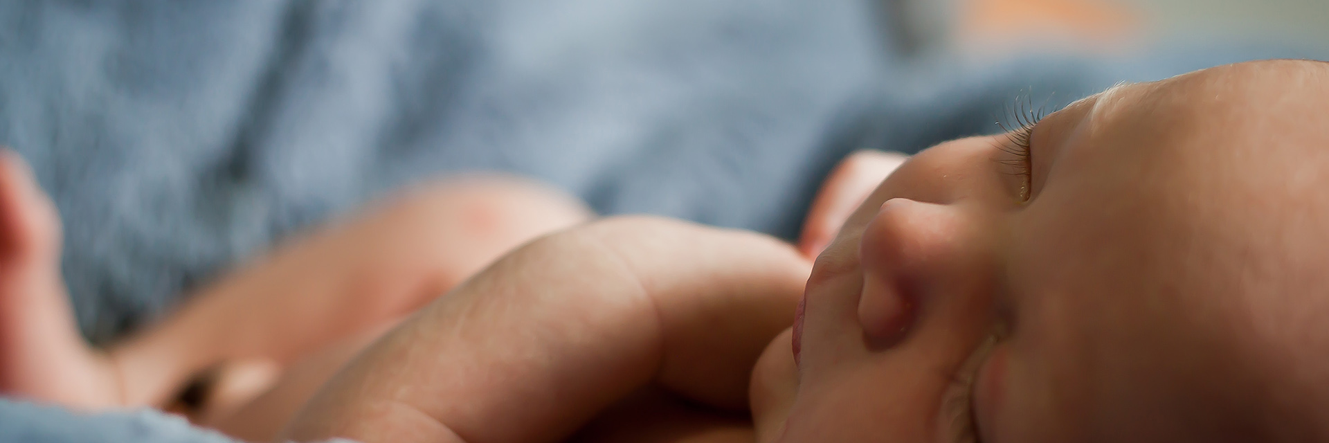 Newborn Sleeping on a Blue Blanket