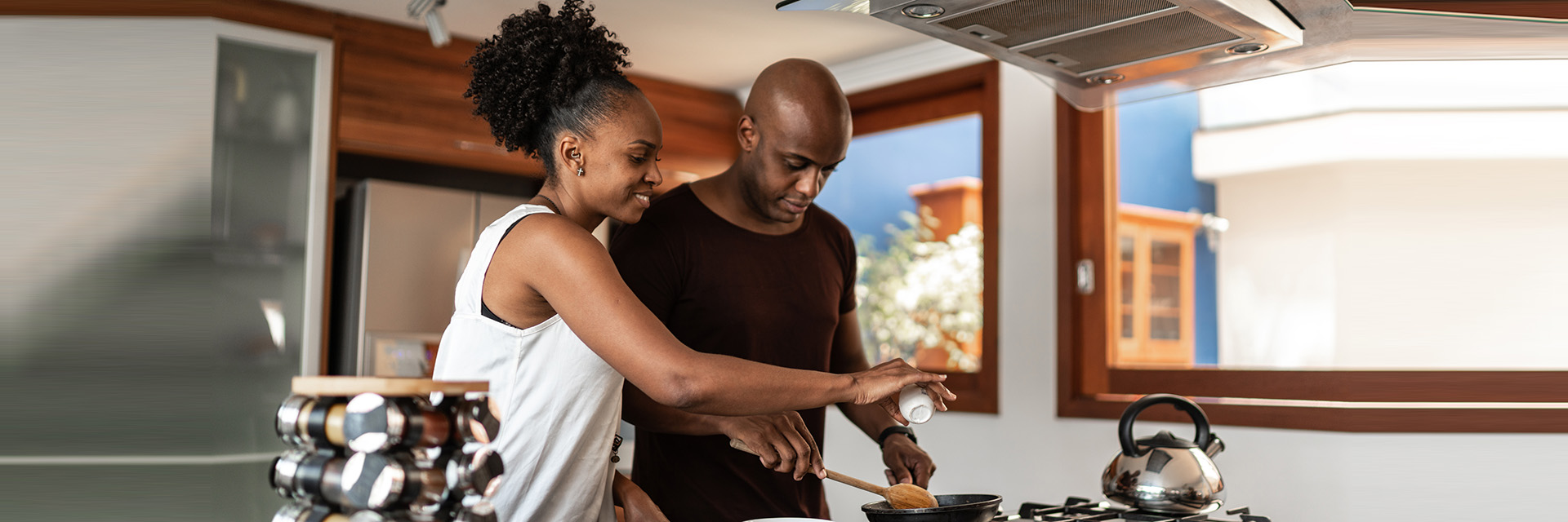 Couple in kitchen cooking