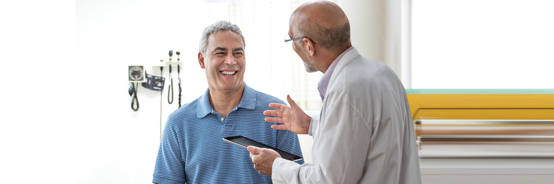 Doctor with patient using tablet