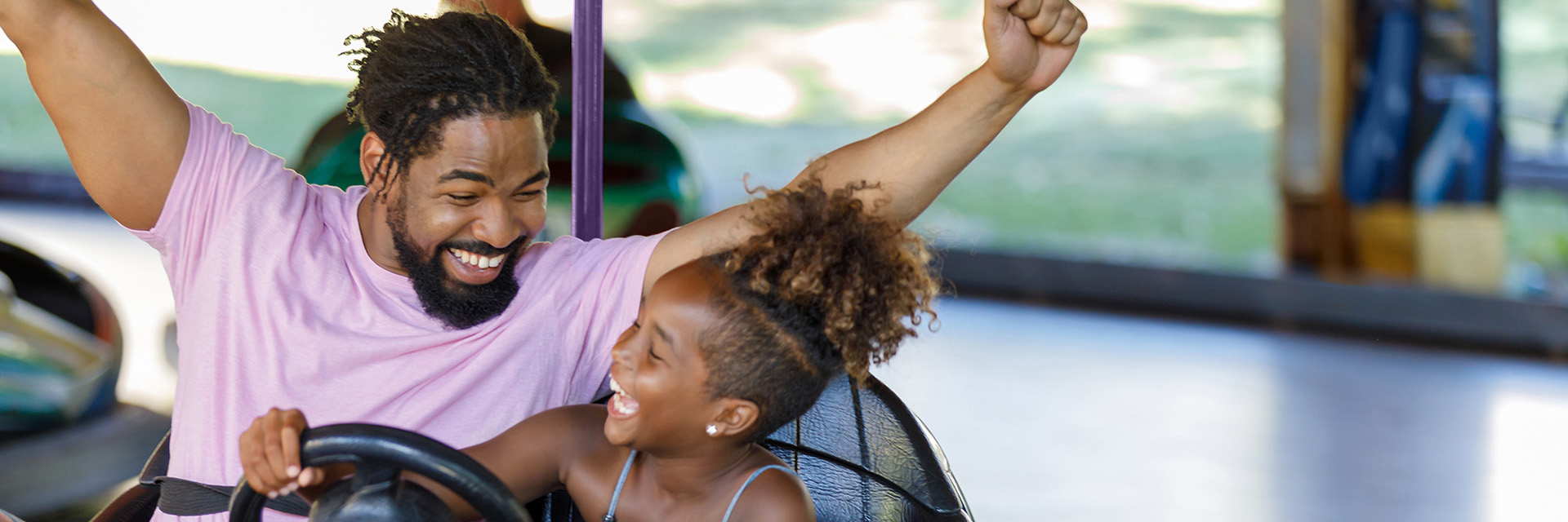 Father and daughter in bumper cars