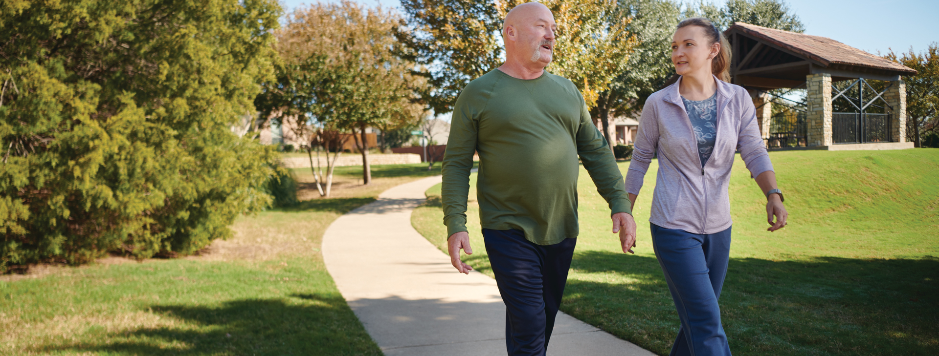 Man and woman walking in park