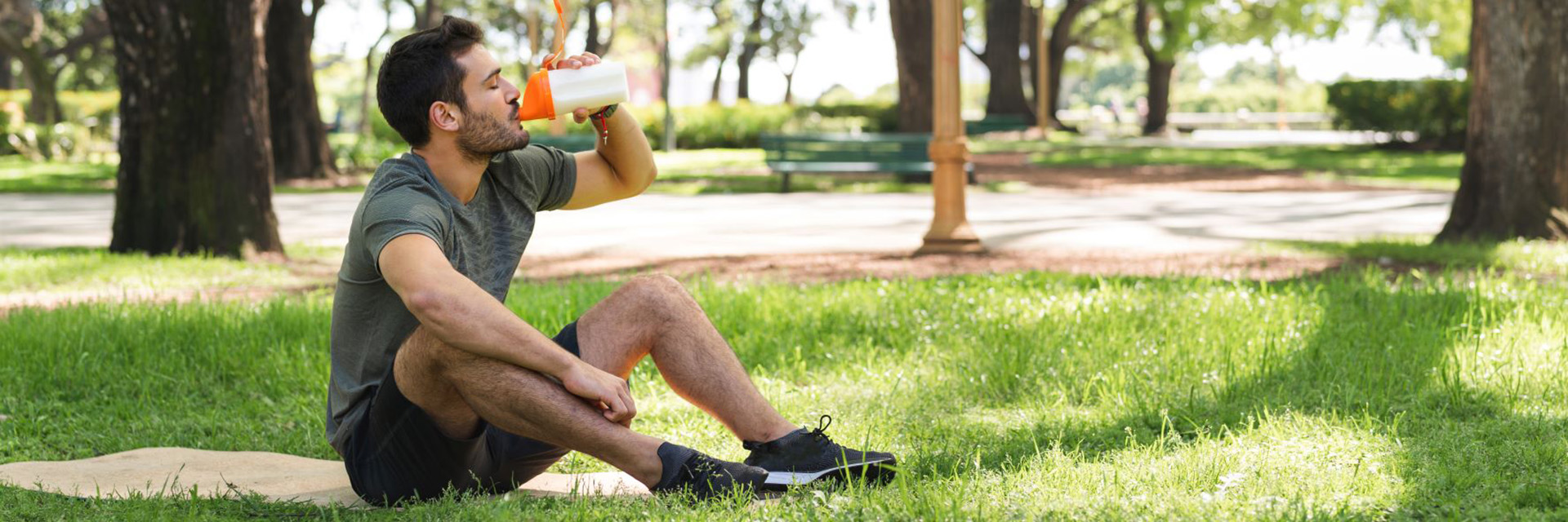 man drinking from water bottle