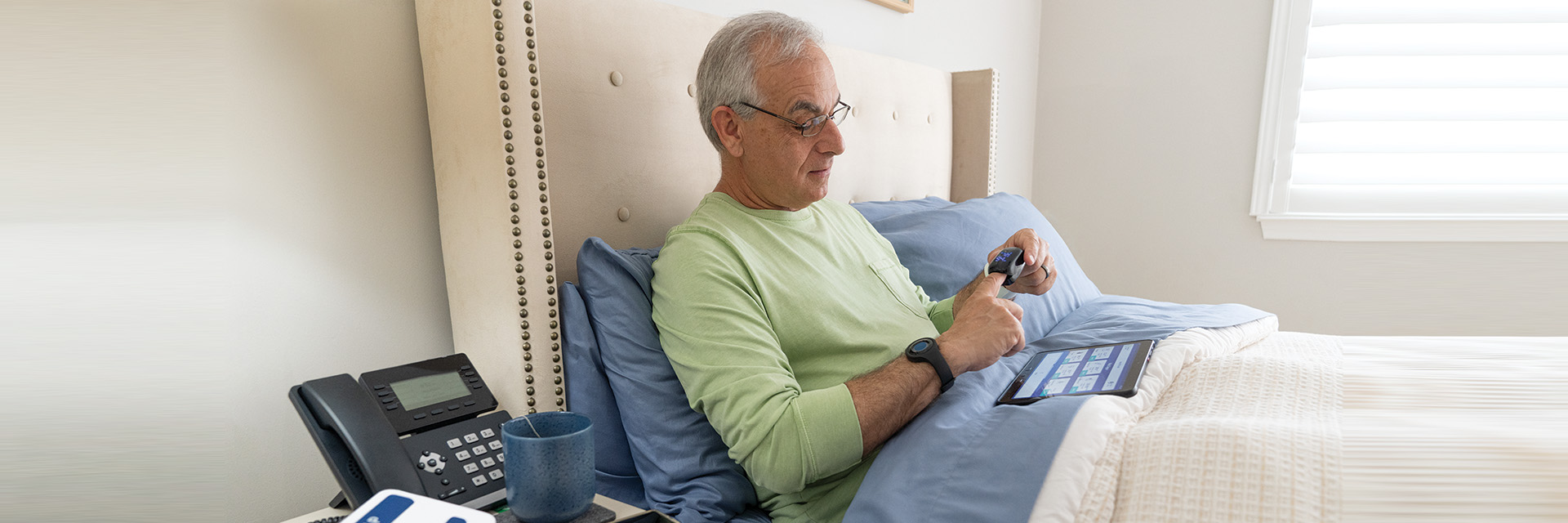 Man on bed with tablet
