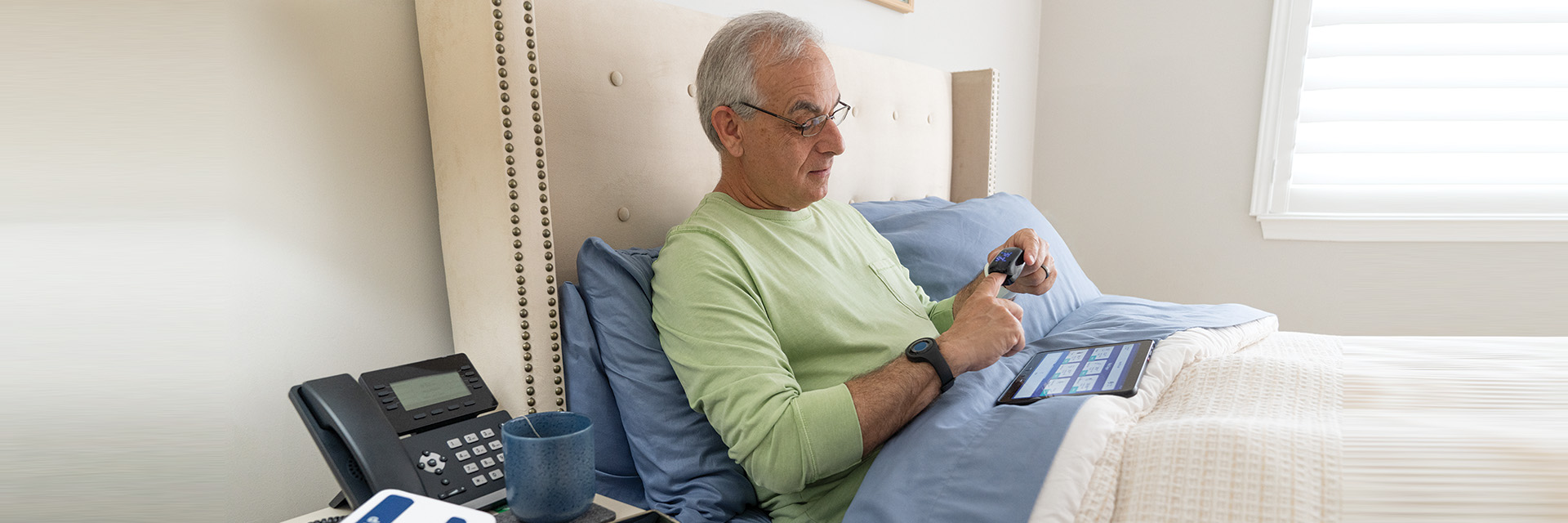 Man on bed with tablet