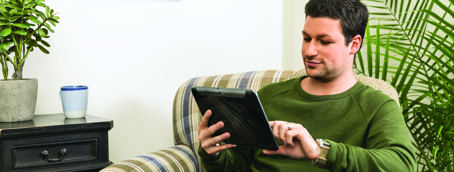 Man sitting in chair on tablet