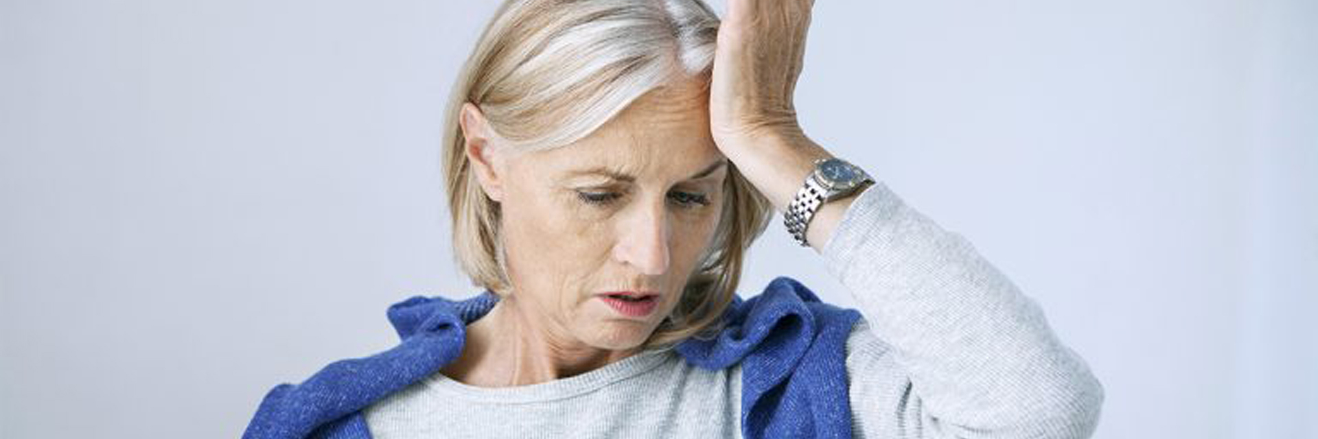 Mature woman holding her head