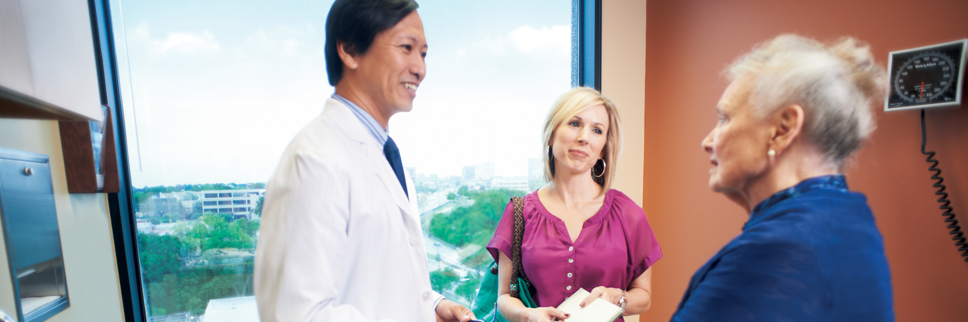 Mom and daughter talking to physician in office
