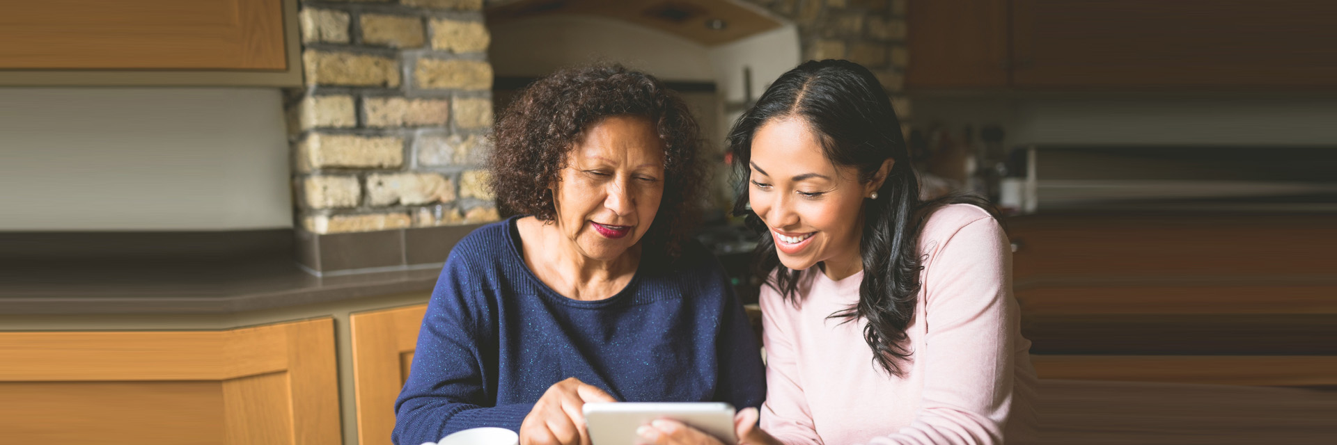 Mother and daughter using tablet