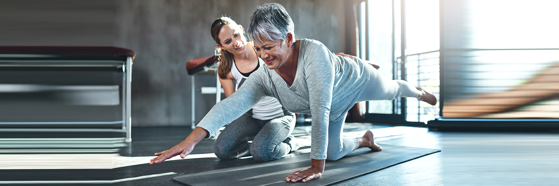 Woman stretching with trainer