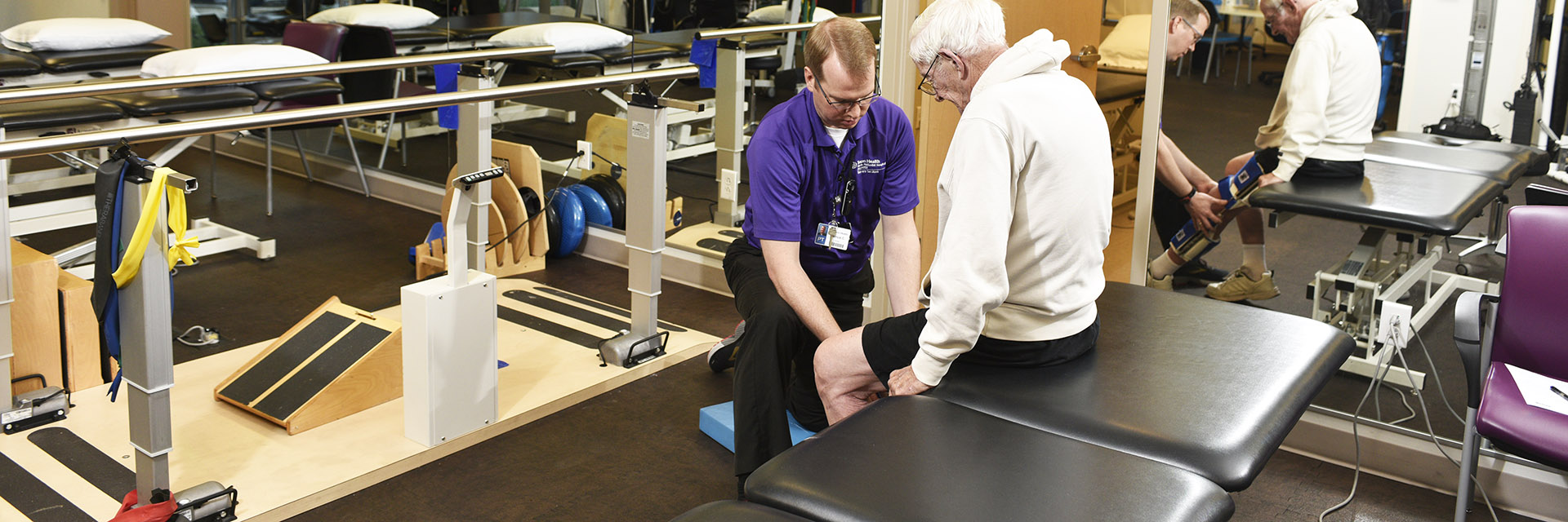 Man Sitting on Bench Working with a Trainer