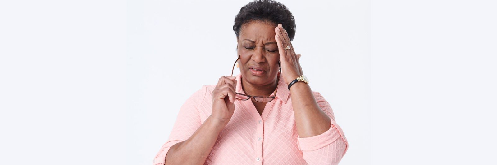 Mature woman touching her head in pain
