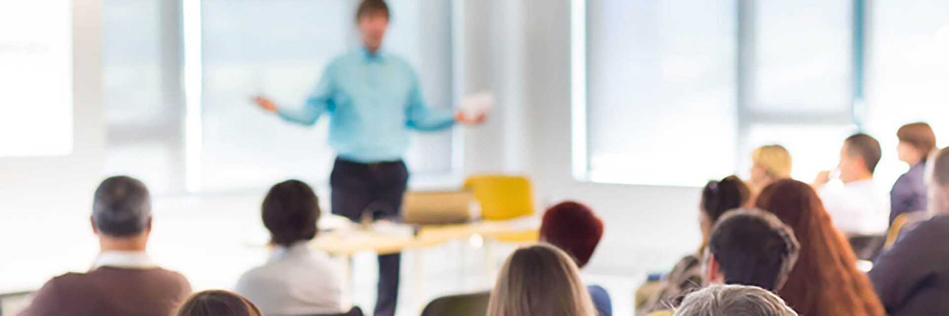 Man Standing in Front of a Classroom