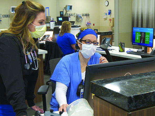 Nurses consulting monitor