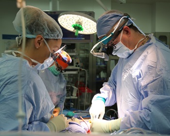 Dr. Mark Pool, right, performing open-heart surgery.