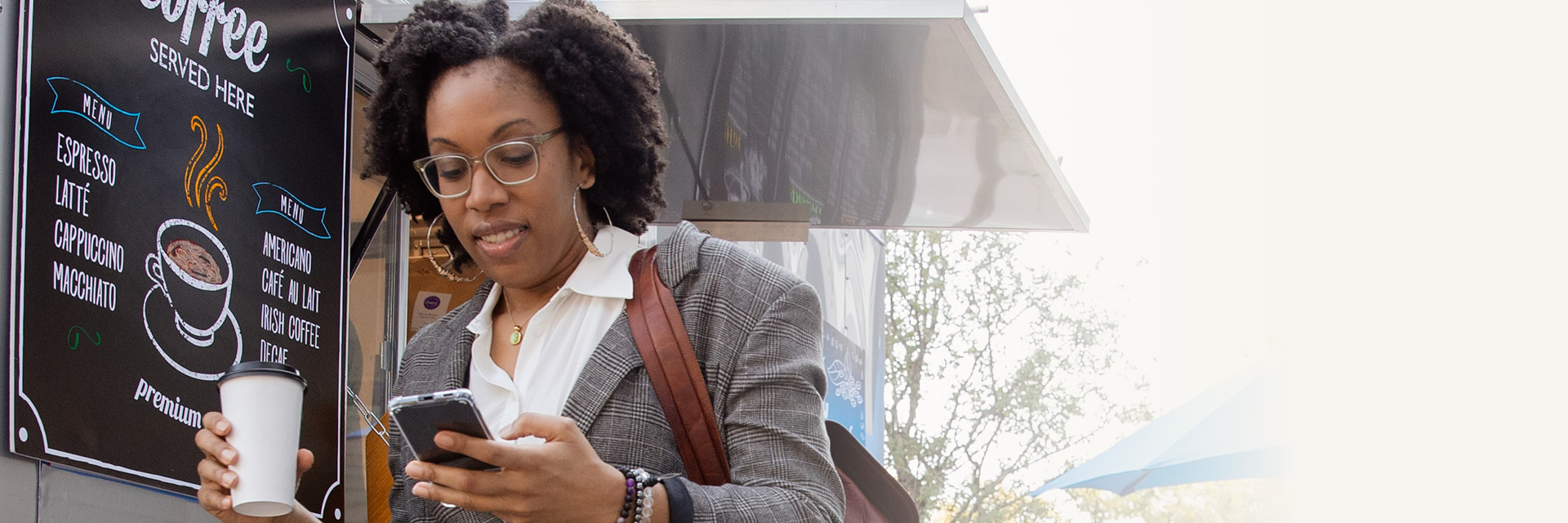 Woman with coffee and phone