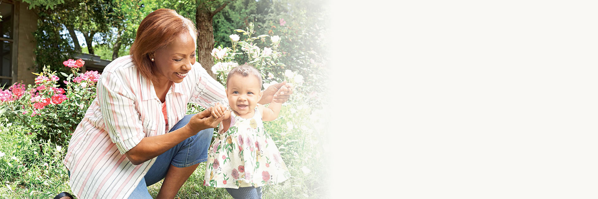Grandmother holding and walking granddaughter