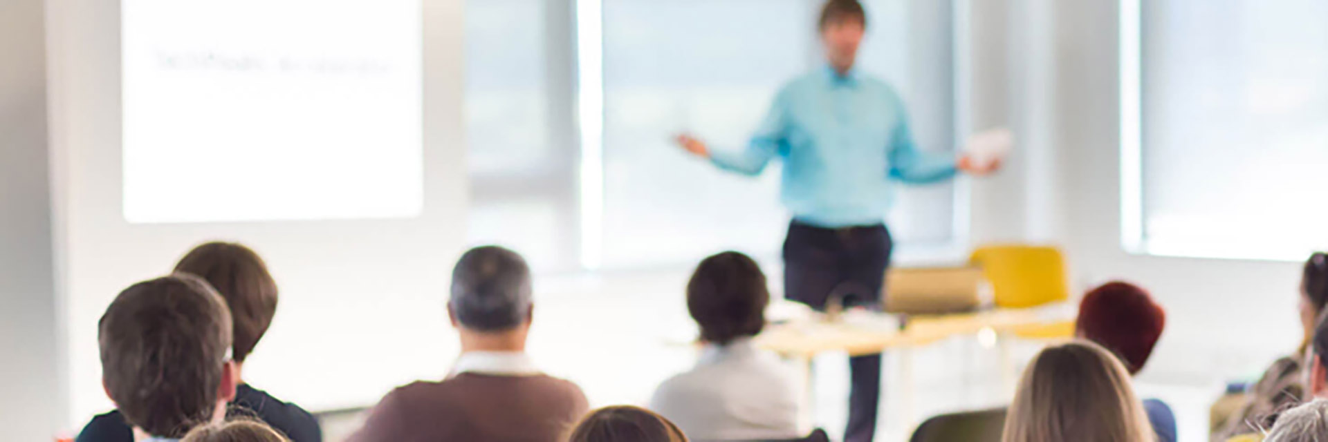 Man Standing in Front of a Classroom