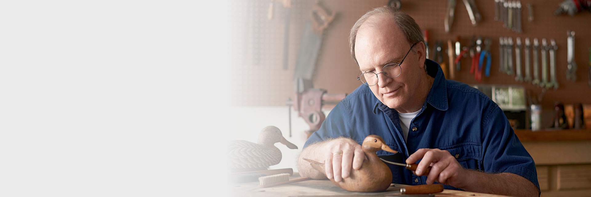 Man carving wooden duck