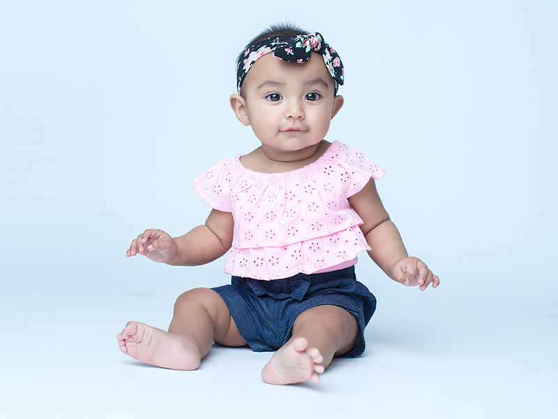 Baby girl sitting and smiling
