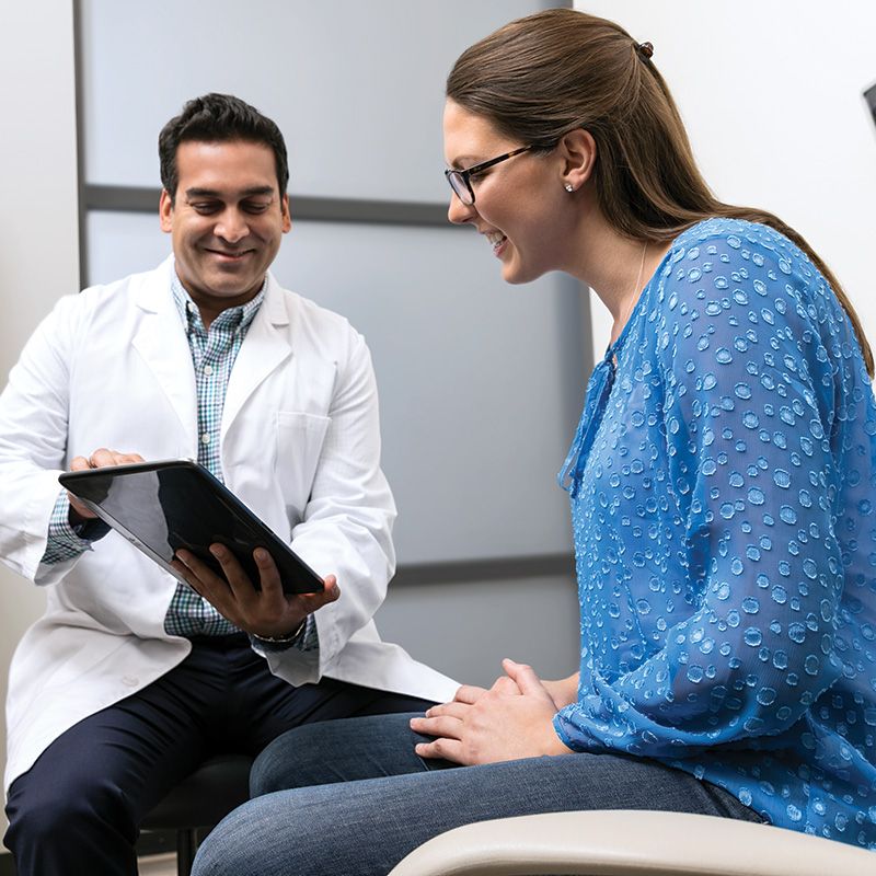 Doctor Showing Patient Tablet