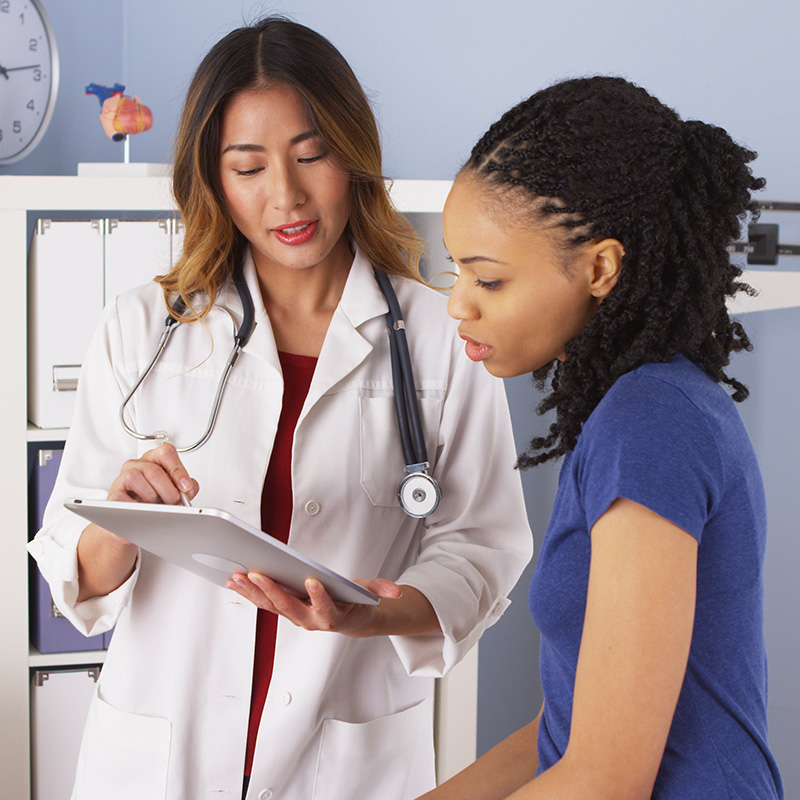 Doctor with patient using tablet