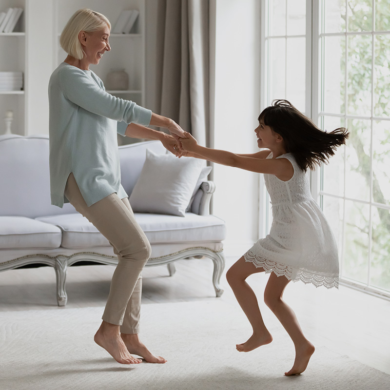 Grandmother and girl dancing