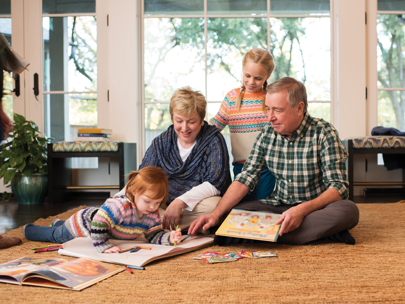 Grandparents playing on the floor with grandchildren