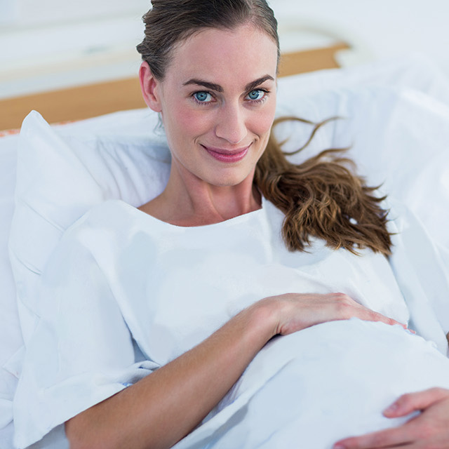 Pregnant woman holding stomach