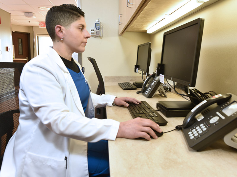 Nurse typing at computer