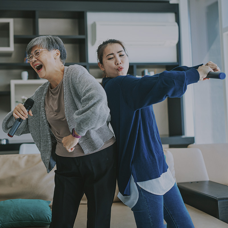 Two females singing karaoke