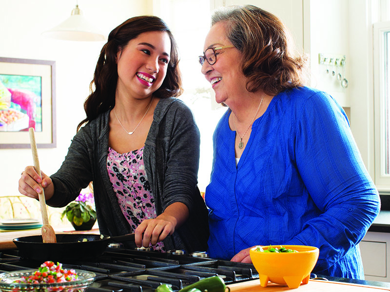 Grandmother and granddaughter cooking in the kitchen