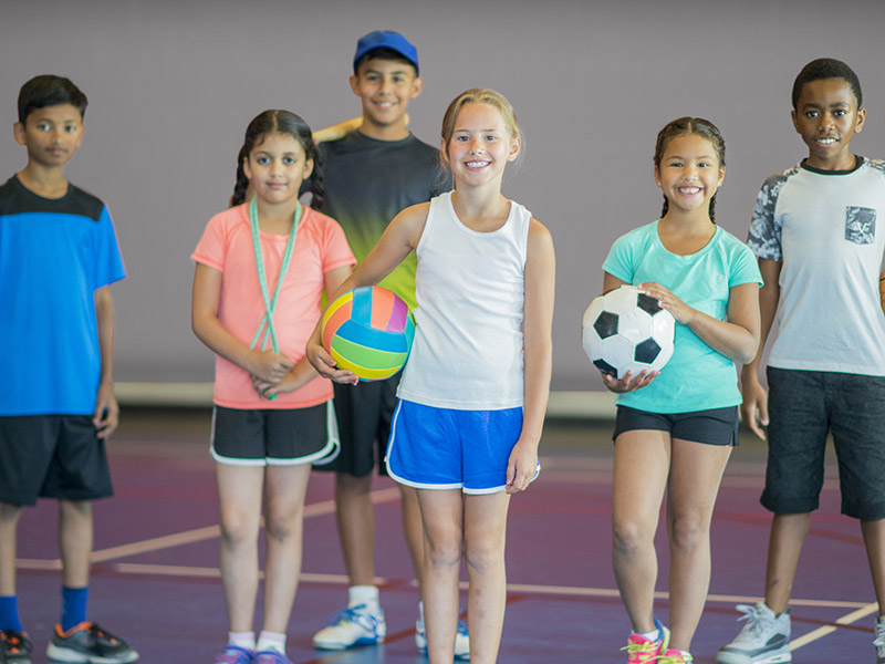 Kids in Gym Getting Ready to Play Sports