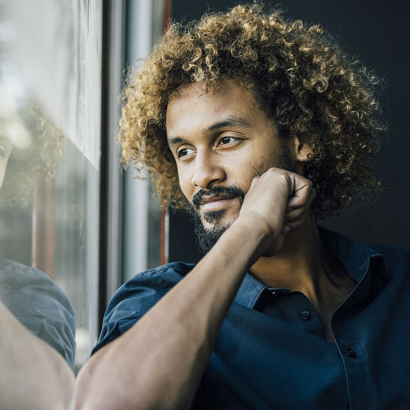 Man Looking Out Window