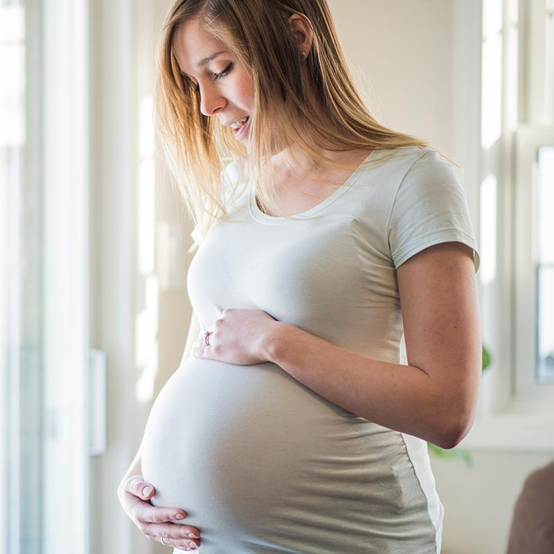 Pregnant woman holding stomach