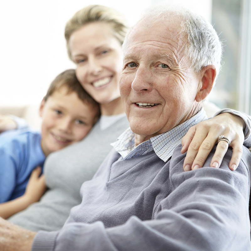 Senior Man Sitting with Family