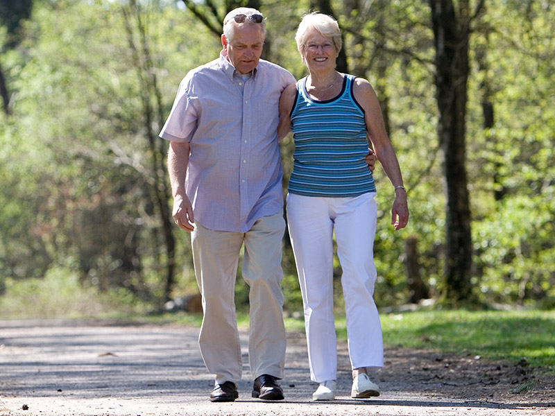 Couple walking outdoors in the park 