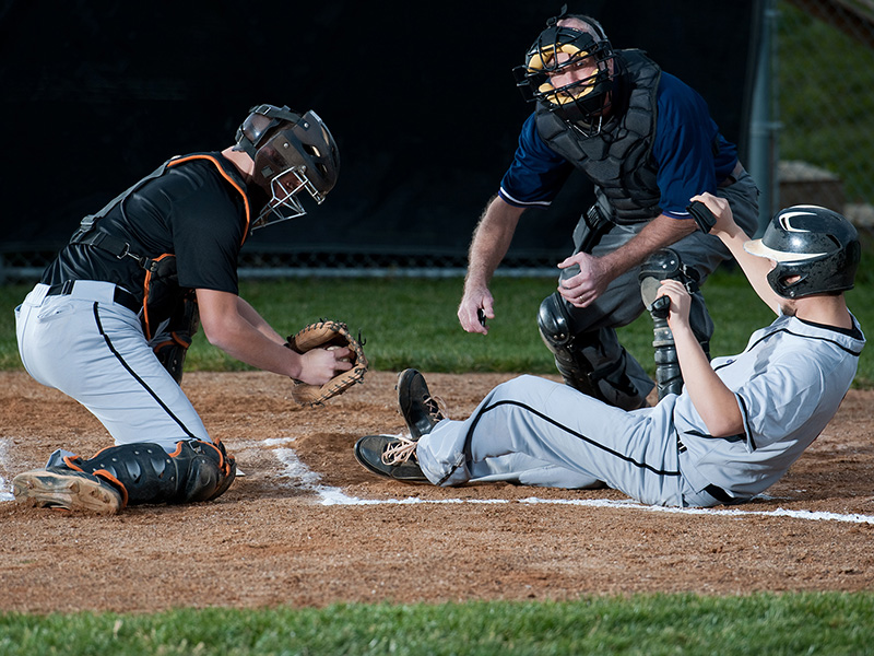 Baseball player sliding home