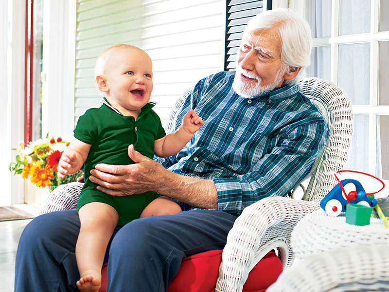 Grandfather sitting with infant