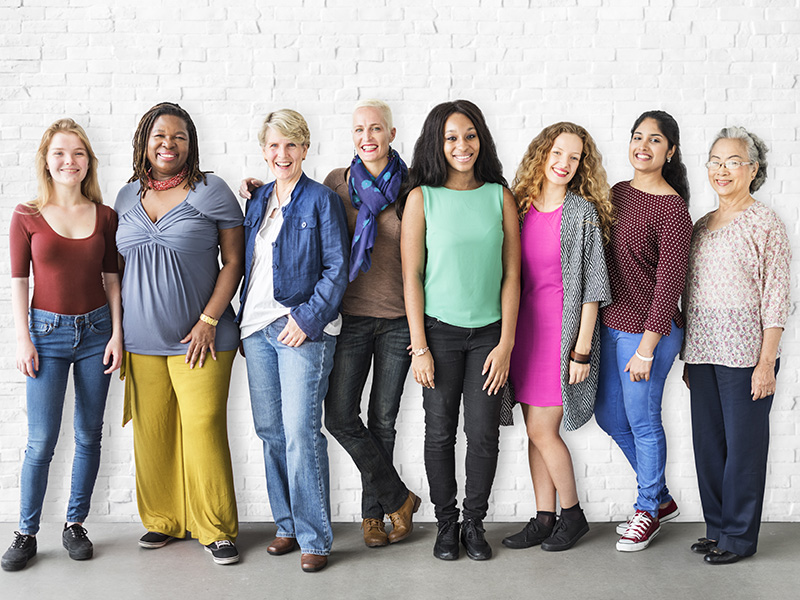 Group of women standing against wall