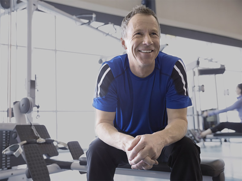 Smiling man resting at gym