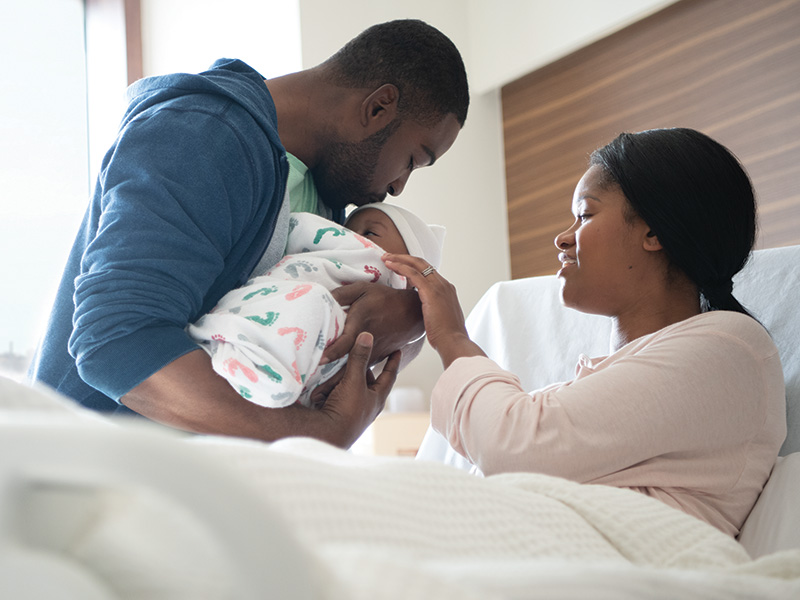 Mom and Dad Holding Baby