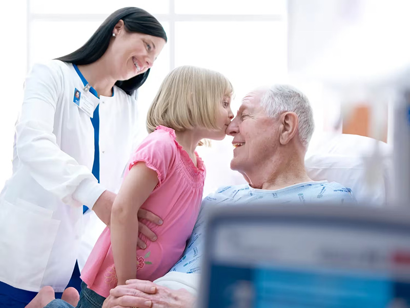 Grandfather and granddaughter in patient room