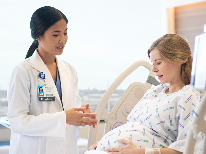 Pregnant woman talking to doctor